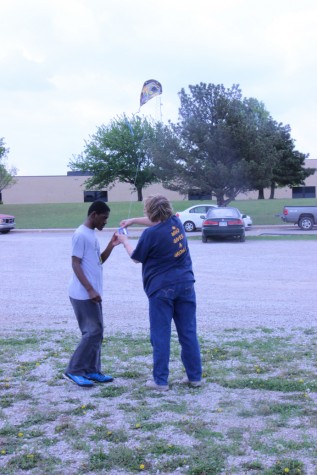 Wallentine hands a kite over to junior Maurice Reed.