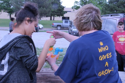 Wallentine and senior Sierra Pierce work on gathering up bubble solution and toys. 