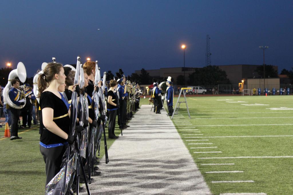 The flag team lines up to go onto the field at halftime.