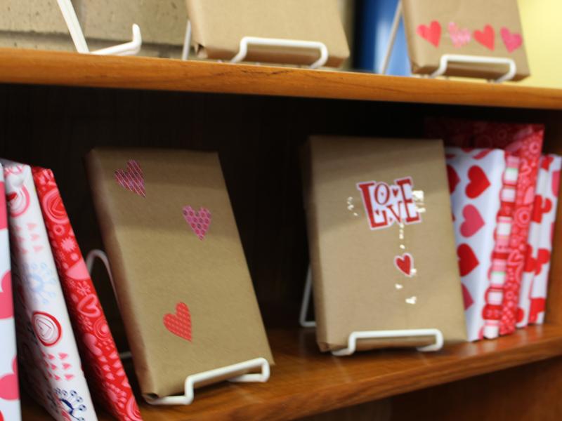 Books wrapped in Valentine-themed paper are available for unwrapping and check-out in the library. 