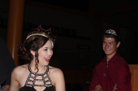 Seniors Andrew Minter and Holly Brown swap crowns after being named homecoming royalty