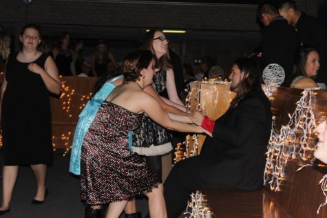 Students seen trying to drag their friend to the dance floor.