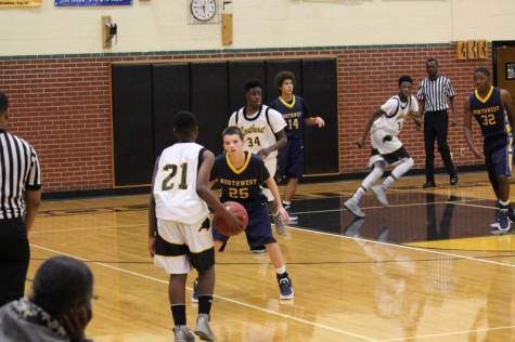 Freshman Lincoln Phillips guards Southeast's #21 on defense in the freshman game.