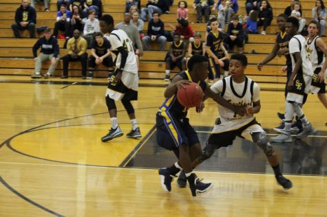 Freshman Roy Johnson dribbles against southeast defense in sophomore game.