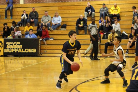 Sophomore Jake Carter dribbles against Southeast defense in sophomore game.