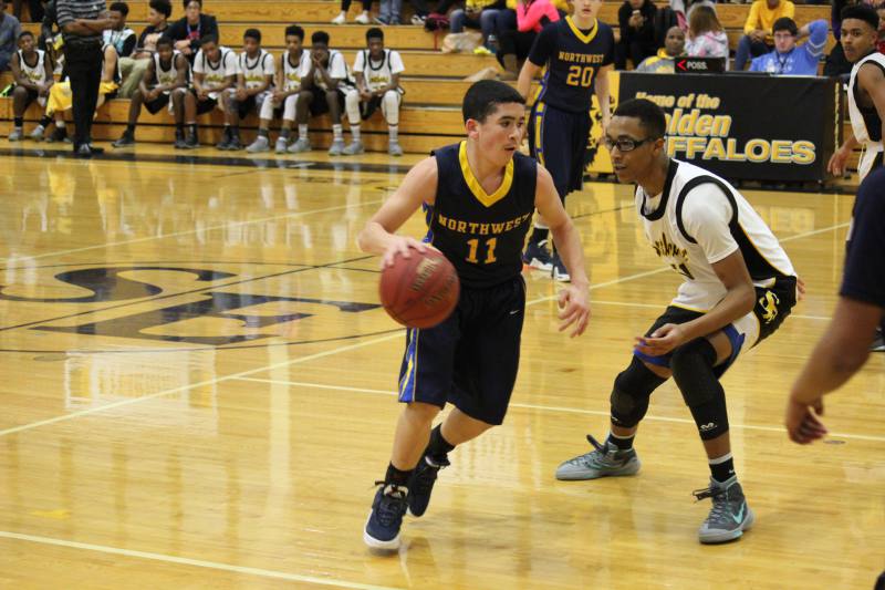 Sophomore Chase Taylor dribbles down court against Southeast defense.