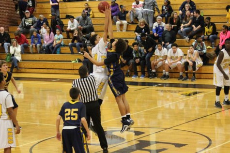 Freshman Kale Patterson jumps at the tip off of the sophomore game at Southeast.