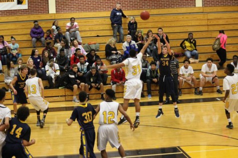 Freshman Jacob Harmon shoots a 3-pointer in the freshman game.