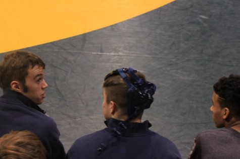 Senior Kevin Folsom, senior Cameron Yale, and senior Justin Onwugbufor chatting between matches.