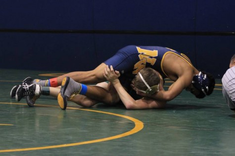 Sophomore Devin Onwugbufor ready to pin his opponent. 