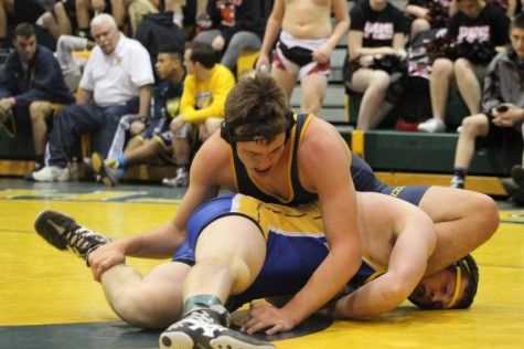 Junior Adam Baker wrestling a Hutchinson wrestler.