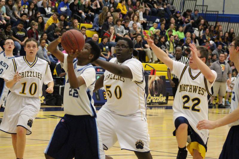 Michael tries to block the shot.