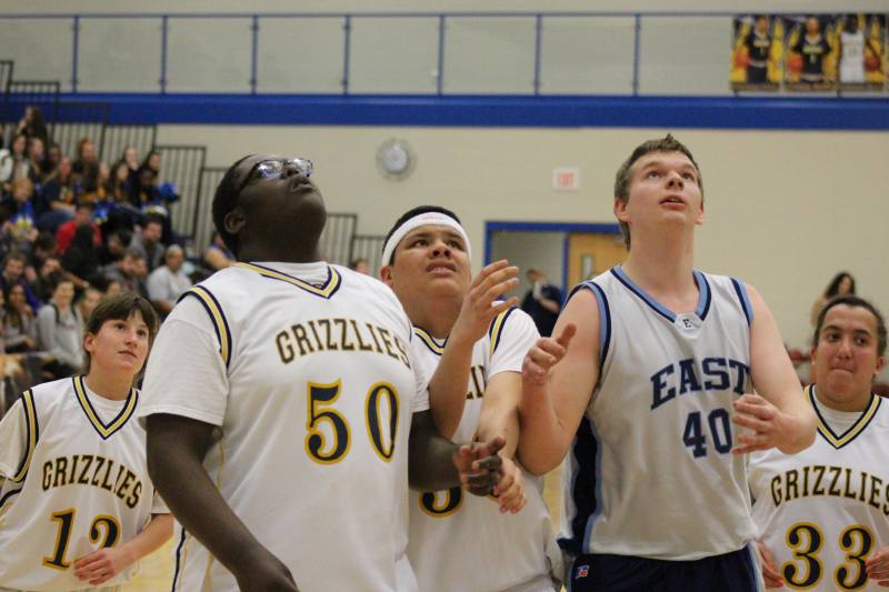 Sophmore Michael White and an East player watch as the ball goes up.