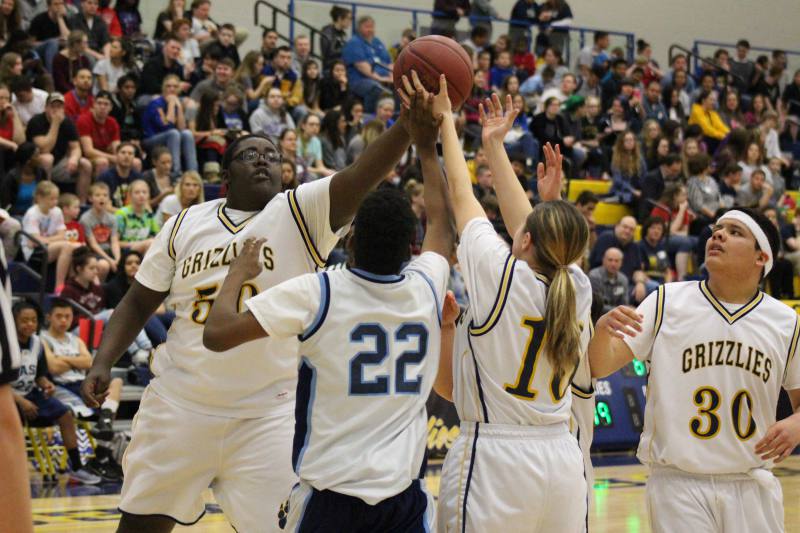 Michael blocks the ball against an East player.