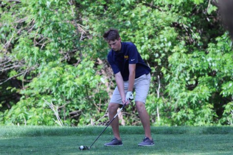 Sophomore Ethan Allen setting up to hit the golf ball at MacDonald golf course Monday, April 25.