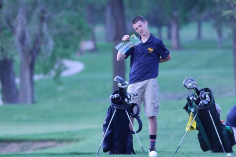Freshman Lincoln Phillips looking a map trying to figure out where to go to the next hole at MacDonald golf course on Monday, April 25.