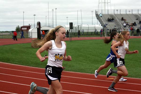 Caroline Fincham(9) and Madi Harkins(9) run the 800 meter on March 30 at the Maize JV track meet. Photo by Bloom