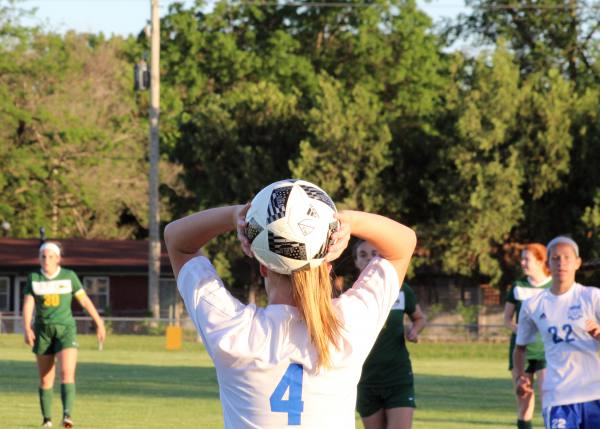 Sophomore Madison Driskill throws in the ball after it goes out of bounds at Tuesdays Varsity soccer game against Bishop Carroll. 