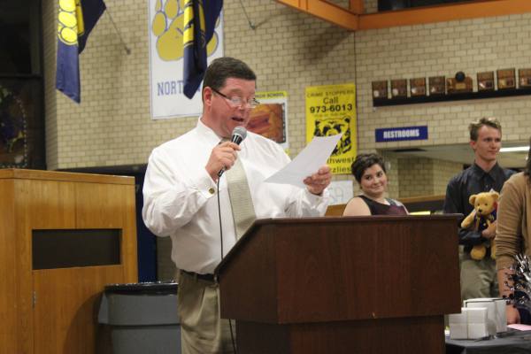 Dr. Leopold reads names as he gives awards to the instrumental students