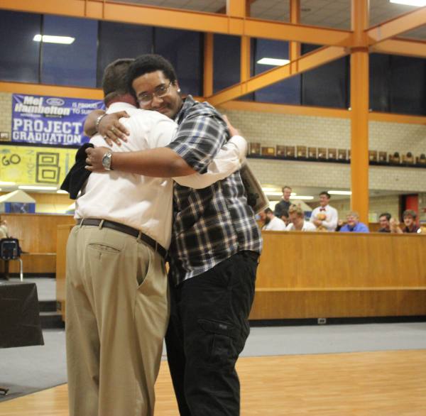 Dominic Davis accepts an award from Dr. Leopold recognizing his achievements