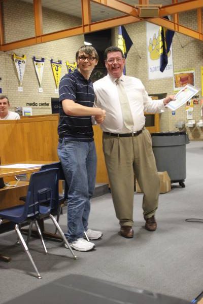 Chris Kliewer shakes hands with Dr. Leopold. He accepted an award for outstanding achievement and participation. "I did this for you, i hope you got a picture," Kliewer said.