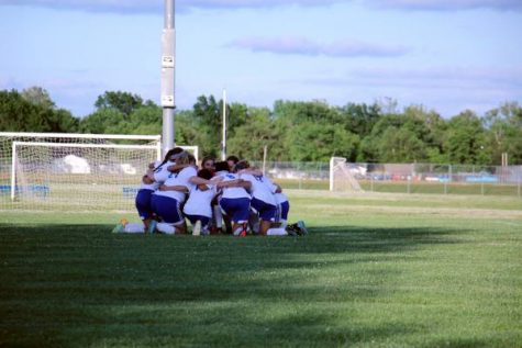 Northwest women's varsity conducts traditional pre-game huddle before taking on Maize.