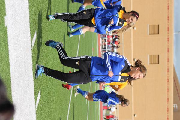 captian senior katie cramer leads the varsity team in stretches right before thier win vs north redskins.