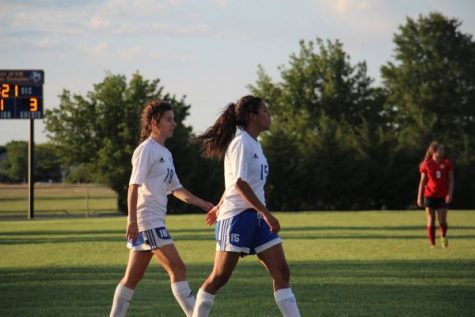 Brittan Murray (9) and Emily Rodriguez (9) walking to next play