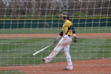 Aaron Rhodes waiting to go up to bat against Olathe East