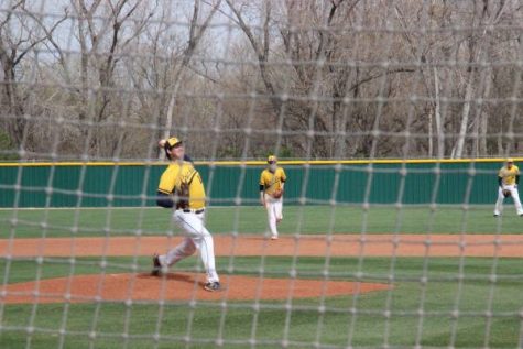 Junior Brady Dingman warms up against Olathe East