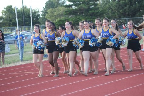 The dance team making their way across the track.