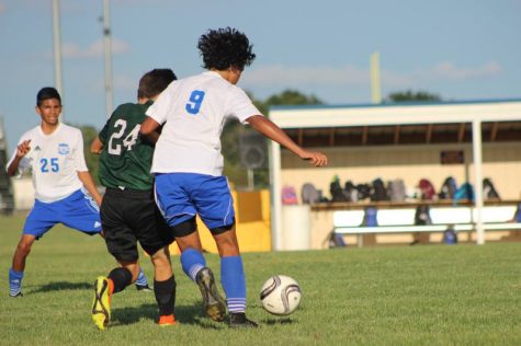 Freshman soccer players defend against Derby opponents.