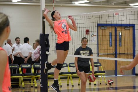 Sophomore Milana Hollinger making a great leap to spike the ball