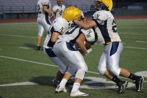 The freshman football team scrimmaging each other.