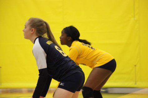 Sophomores Maddie Harkins (left) and Briaja Tucker (right) down and ready to bump the ball to the setter.