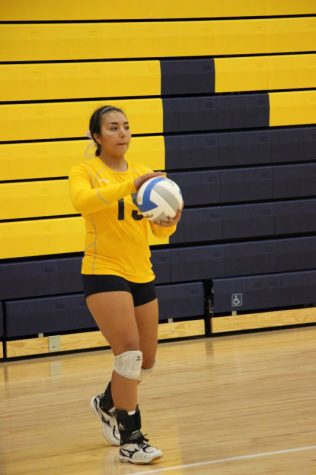 Senior Bella Soliz preparing to serve the ball.