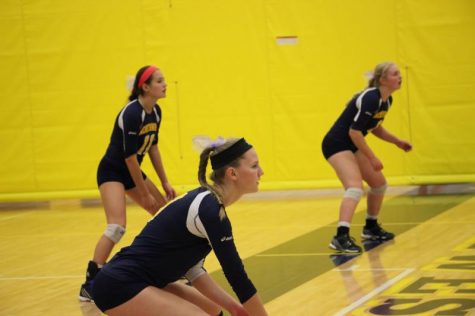 Junior Makenna Medlin, Senior Kylie Acebedo and Junior Lucy Herter wait to receive the ball.