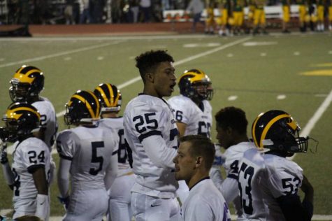 Senior Jorryn Moore supporting his teammates during the last half of the game.