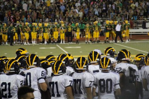 The varsity football team staring at Bishop Carroll in the distance.