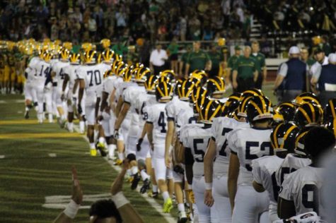 The varsity football team shaking hands, ecstatic for they just won two years in a row. 