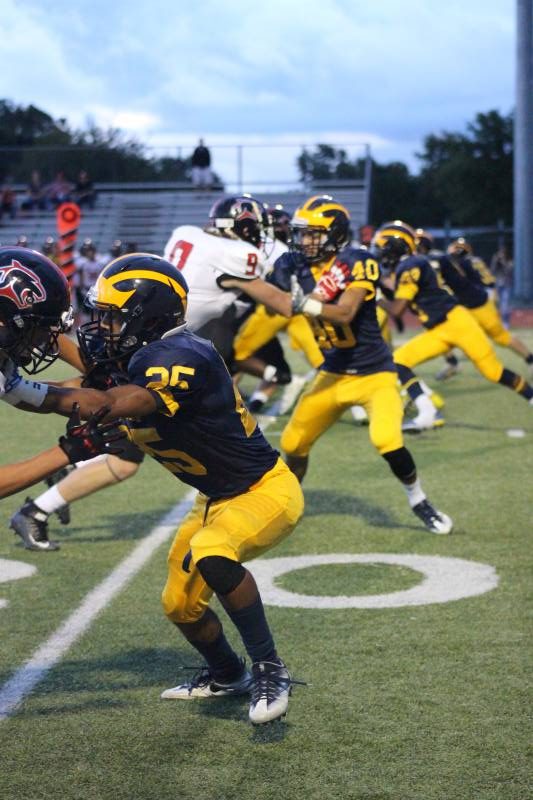 Senior Jorryn Moore and the defensive line up block the opposing team .