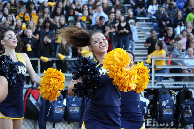 Junior Kristiana Blythe cheering on the football team.