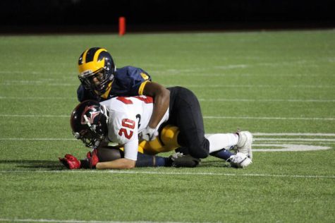 Junior Caleb Belin makes a tackle and stops the ball.