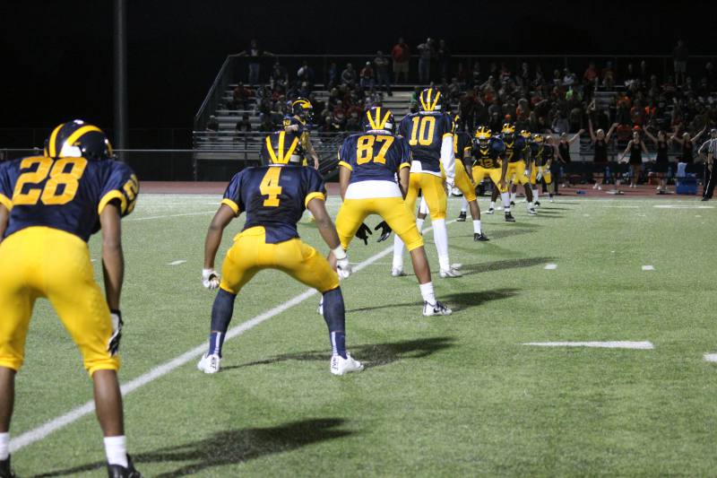 The defensive line waits in position for the kick.