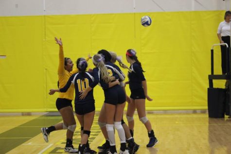 The varsity team huddles up after scoring a point.