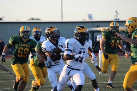 Senior Martese Mullins runs ahead of Senior Emilio San Roman who is carrying the ball.