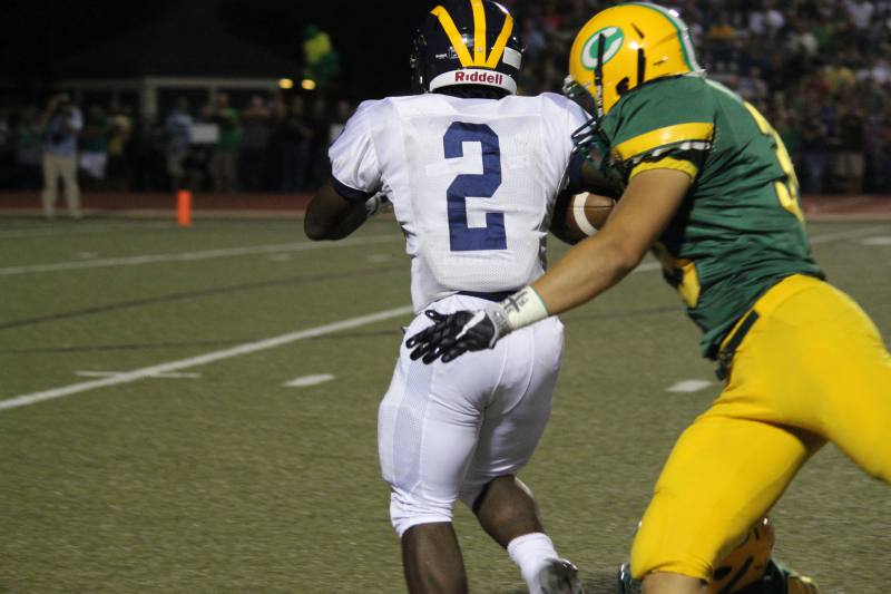 Senior Myles Garner runs with the ball before getting tackled.