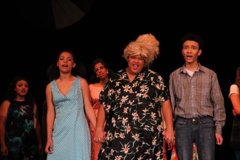 Freshman Gracyn Ross (left), Junior Genovevamary Hood (middle), and Junior Emerson Ross holding hands during an emotional song.