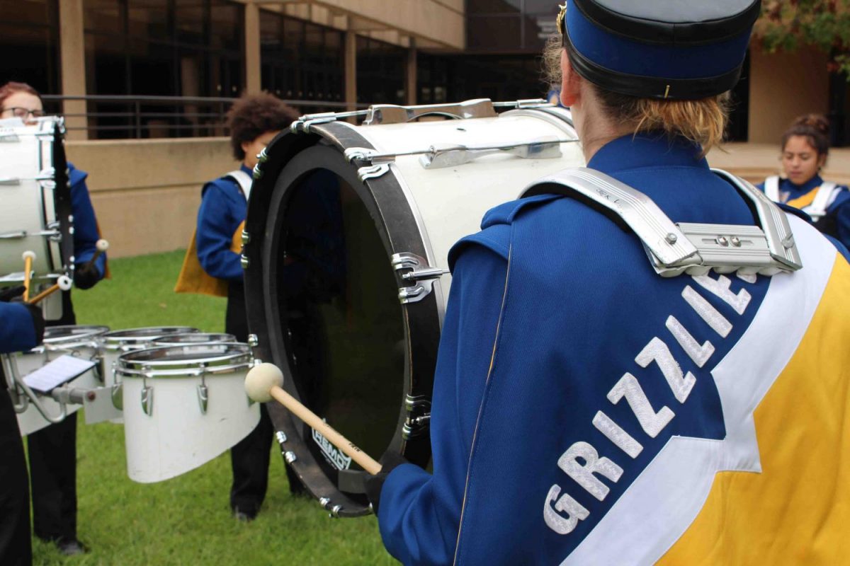 A+percussionist+plays+the+bass+drum+while+practicing+outside+of+Century+II.