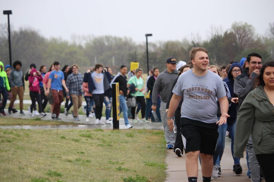 Sophomores exit the building and load the buses.